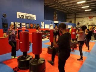 Students moving through a cardio station