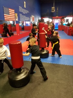 Children learning karate in the dojo