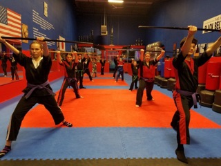 Young students learning karate techniques